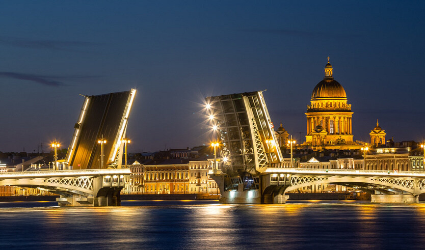 White nights in St. Petersburg. St. Isaac's Cathedral and the divorced Annunciation Bridge – water excursions along rivers and canals